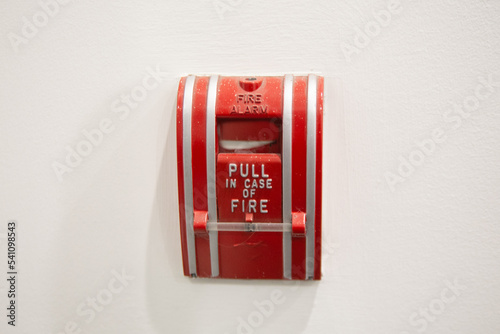 Pull station fire alarm system and mock sprinklers attached to a white wall used for training of security guards. 