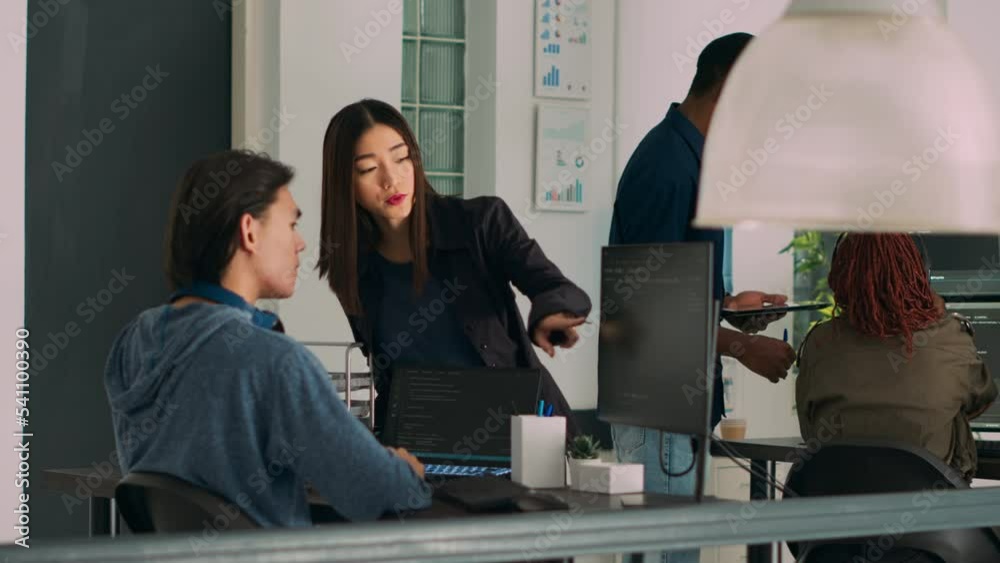 Team of database admins analyzing source code on computer monitor, comparing data script in busy agency office. Two cloud programers debugging algorithm in software developing office.