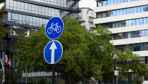 Photo of a round blue road sign with a bicycle. Road sign with an arrow up. Bike lane sign. Comfortable urban environment in the Georgian city of Tbilisi. The concept of caring for citizens of Georgia photo