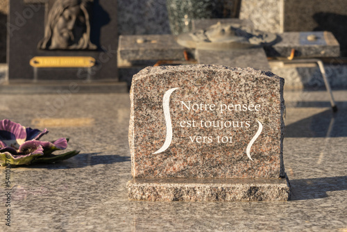 Close-up on a granite funeral plaque, on which is noted in white, the inscription: 