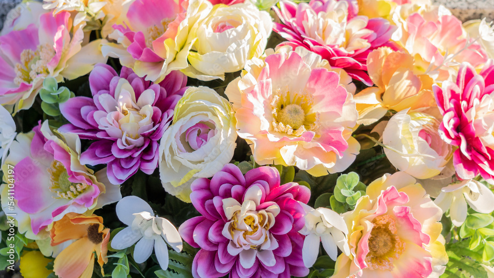 Close-up of a bouquet of artificial flowers, pink, yellow, purple Close-up of a bouquet of artificial flowers, pink, yellow, purple