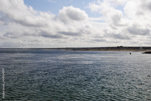 The view of a calm Cape Cod bay on a clear day from the jetty at Scusset Beach State Reservation.