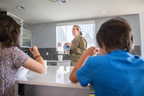 Air Force service member having breakfast with kids before work.