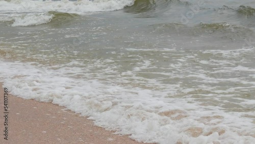 Strong waves with foam on the shore of the Sea of Azov, Ukraine photo