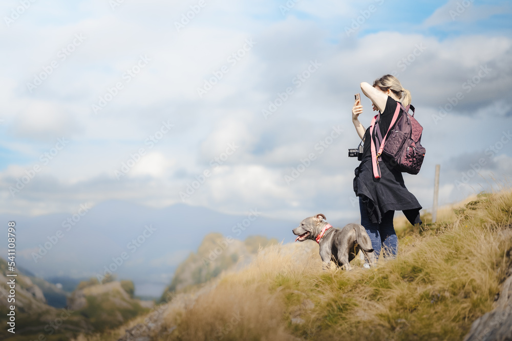 woman with dog on hike