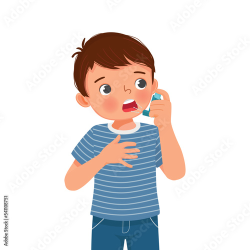 Cute little boy using asthma inhaler nasal spray bottle to treat allergy asthma attack and breathing treatment
