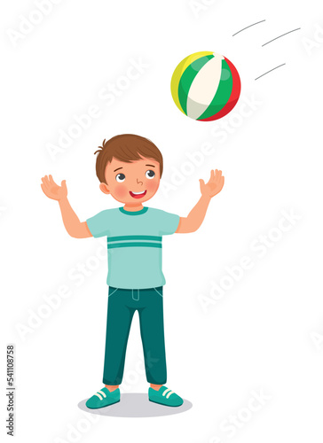 Happy little boy playing catching a ball 