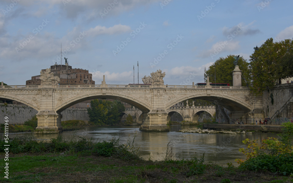 Bridges crossing the Tiber river in Rome Italy on a fall day.