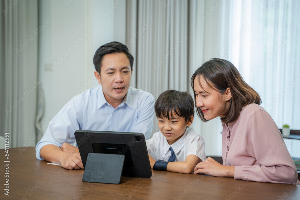 Parents helping little son with school homework,Homeschooling concept. Parents helping little son with school homework,Homeschooling concept.