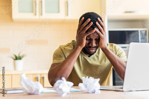 Obraz na plátně Man crushed paper while working and have no idea remote work in kitchen
