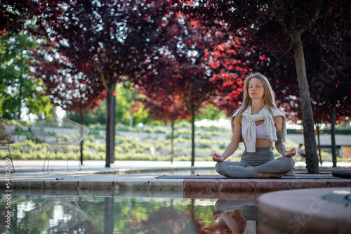 Girl practice yoga meditation outdoor in park © grthirteen