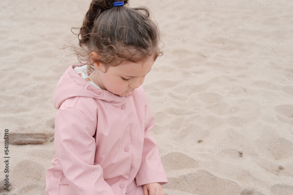 Expressive young girl is playing on the beach on a very foggy day Expressive young girl is playing on the beach on a very foggy day