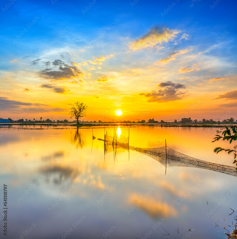 Sunset along the river flooded swampy countryside as the sun down horizon really dramatic end of a sunny day. Sunset along the river flooded swampy countryside as the sun down horizon really dramatic end of a sunny day.