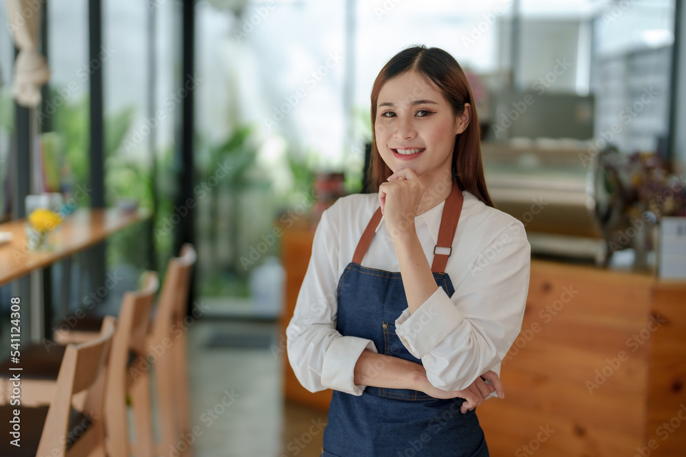 smiling asian woman the owner of the coffee shop stood waiting to open the shop, waiting for customer service and waiting for customer service with a smile. smiling asian woman the owner of the coffee shop stood waiting to open the shop, waiting for customer service and waiting for customer service with a smile.