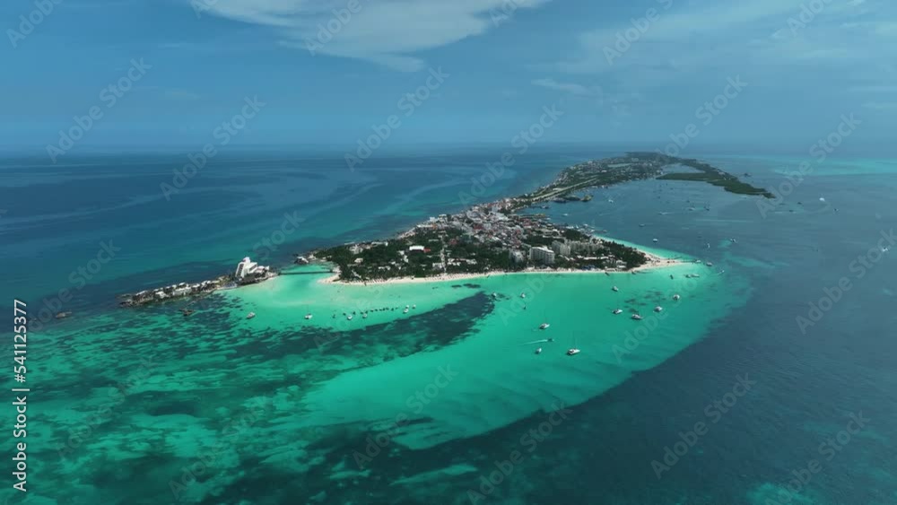 Aerial view of boats in turquoise waters, on the coast of Isla Mujeres, Mexico - approaching, drone shot