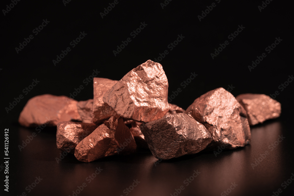 Ingots of pure copper or pink gold on a black background. - obrazy, fototapety, plakaty 