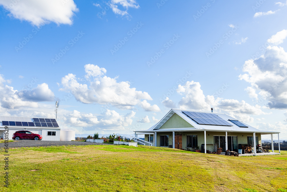 Sustainable off grid living with solar panels on house and shed roof