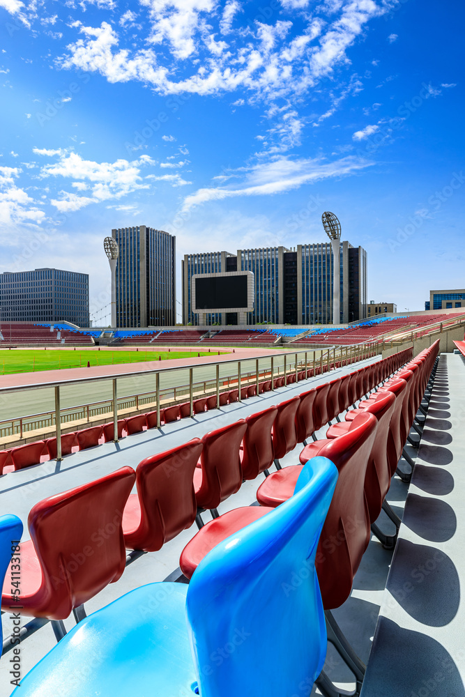Red seats and modern architecture with sky clouds in the stadium