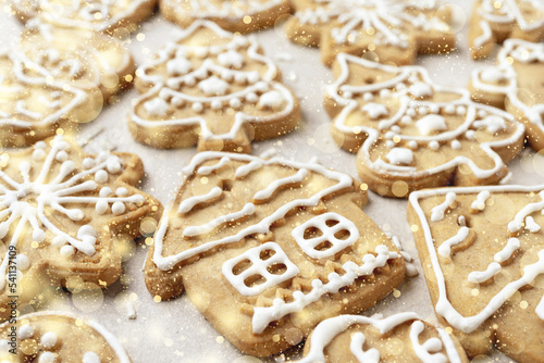 Close-up of Christmas pastries on a light background with golden snowflakes © hannamartysheva