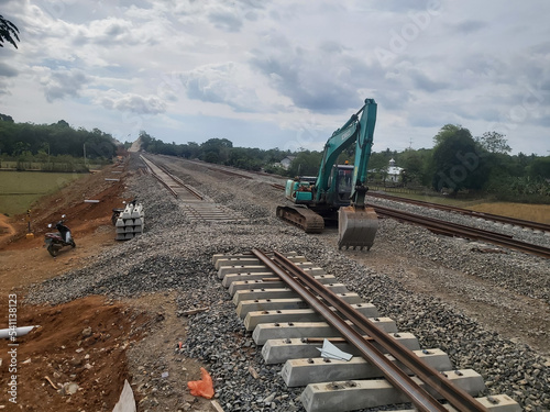 Makasar, Indonesia - September 2022: Excavator, Construction of Mangilu station and train line Makassar - parepare. photo