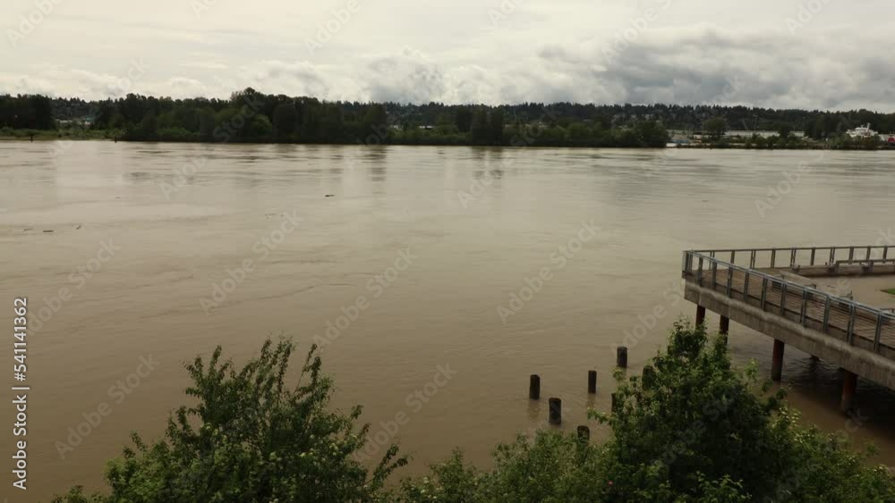 Yellow river in Canada with floating logs on cloudy day Yellow river in Canada with floating logs on cloudy day