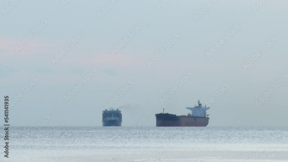 Two cargo ships waiting near the port of Vancouver in the calm waters