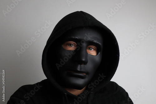 man with black hoodie wearing a black mask photo