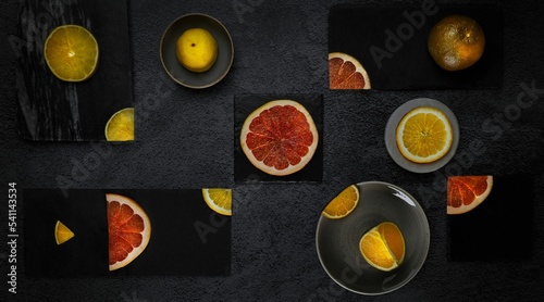 View of cutted different citrus fruits in gray background