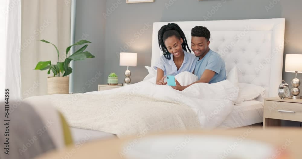 Couple, bedroom and phone video call of black people in bed talking with happiness. Happy girlfriend and boyfriend with a smile using technology in the morning in a house bed with a conversation Couple, bedroom and phone video call of black people in bed talking with happiness. Happy girlfriend and boyfriend with a smile using technology in the morning in a house bed with a conversation