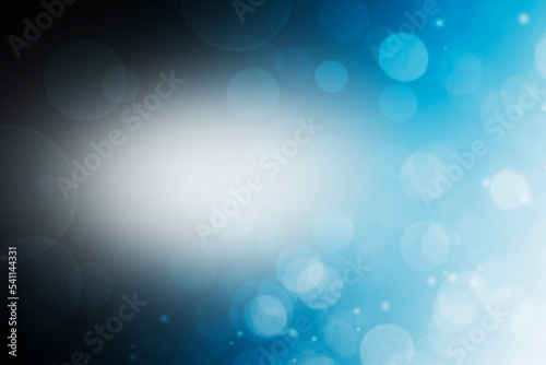 Abstract Bokeh Light effect. Blurred Sparkles Dark Background. Galaxy Space Background. Gradient Blue and Black. 