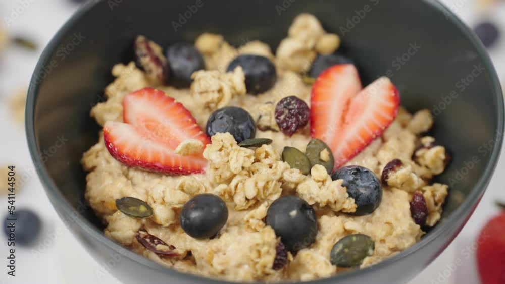 Close up of healthy breakfast, vegan food concept oatmeal porridge bowl with stawberry , blueberry and grains. Clean eating, dieting. Close up of healthy breakfast, vegan food concept oatmeal porridge bowl with stawberry , blueberry and grains. Clean eating, dieting.