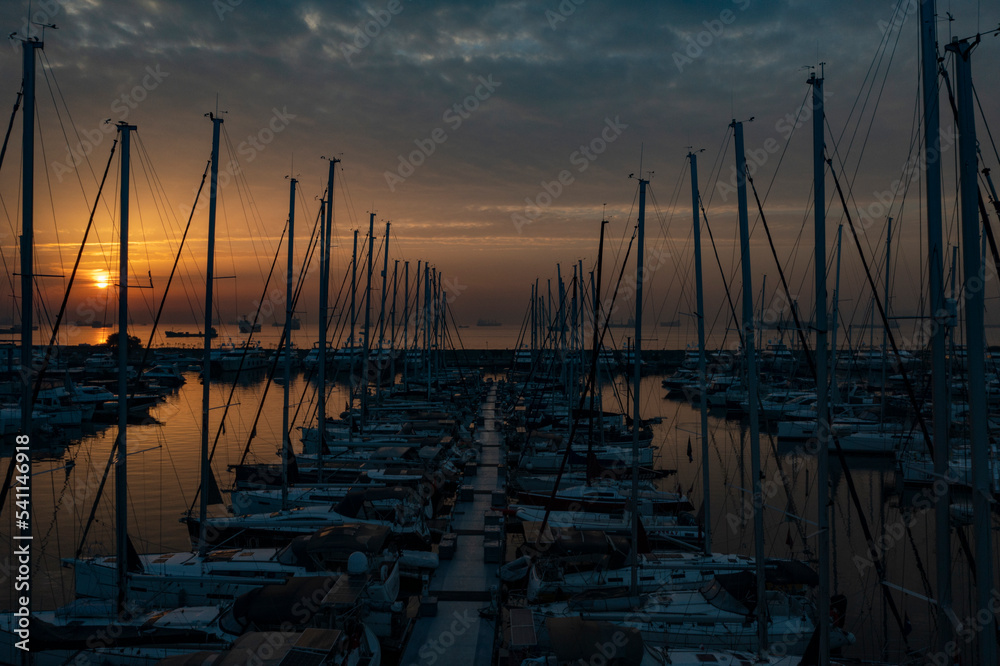 sailboats and sunrise in the marina