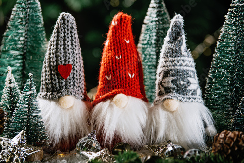 Merry christmas. Christmas composition with gnome and festive decorations on wooden background. Christmas or New Year greeting card. Noel gnome background. Christmas symbol. Happy Holidays. photo