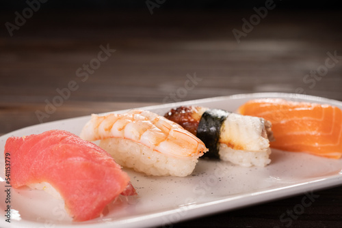 Seafood delicatessen nigiri sushi on plate. Different gourmet snacks. Expensive food, restaurant menu. traditional Japanese food, tasty seafood, food background