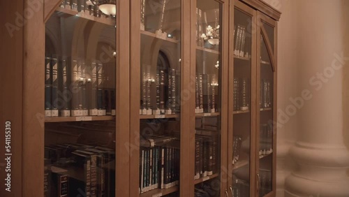 Modern Jewish library in Synagogue. Bookshelves with volumes. Traditional books in Judaic library: Torah, Talmud. Historic building of Jewish community. House of Jewish Spirituality and Divine Law.