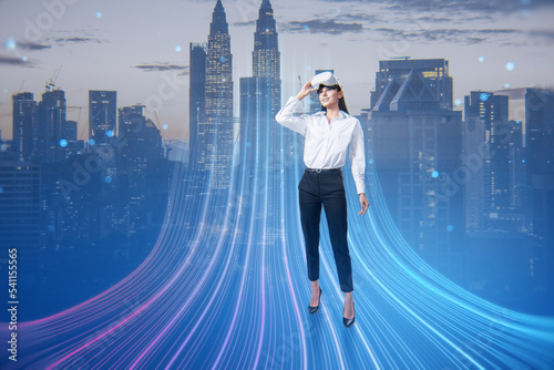 Fototapeta Naklejka Na Ścianę i Meble -  Attractive young european businesswoman with VR glasses and abstract glowing big data or metaverse hologram on blurry city background. Future and digital world concept. Double exposure.