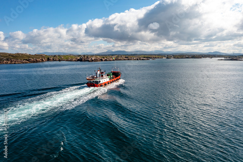 The red Arranmore ferry leaving the Island towards Burtonport, County Donegal, Ireland