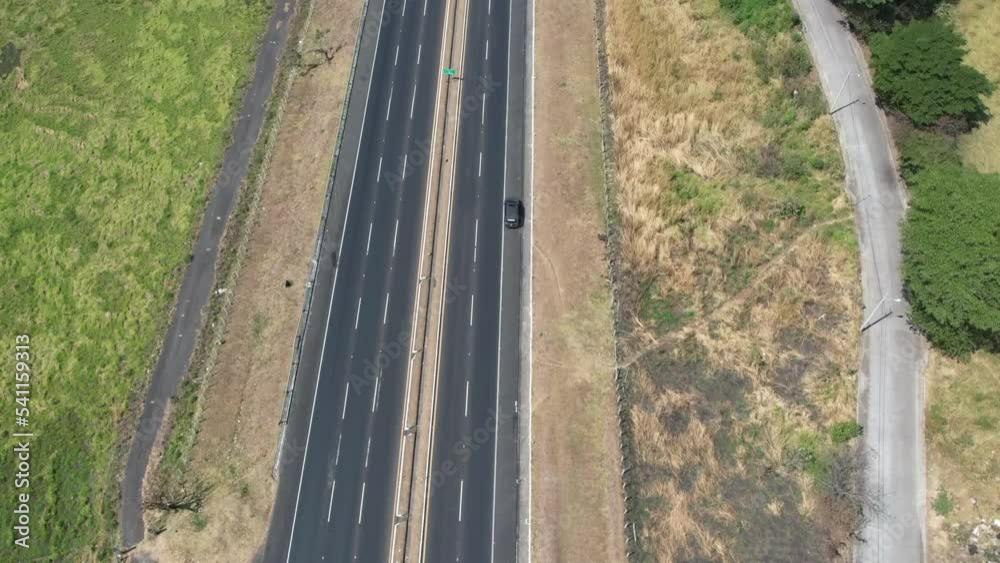 Timelapse from aereal view with drone following a car in a freeway in Escuintla Guatemala Timelapse from aereal view with drone following a car in a freeway in Escuintla Guatemala