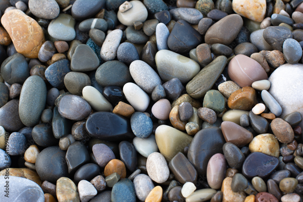 Wet round pebble stones on the beach smooth. Top view. Wet round pebble stones on the beach smooth. Top view.