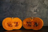 on a dark gray background - pumpkins in section lying on a wooden board. space for the text at the top