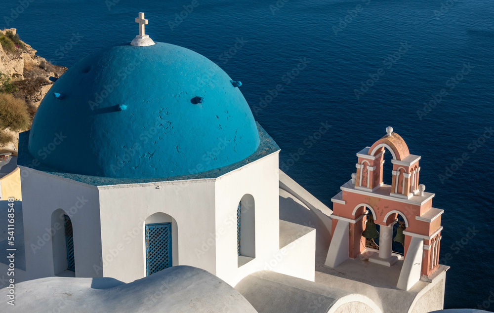 Blue-domed Green Orthodox church at Oia town on Santorini island