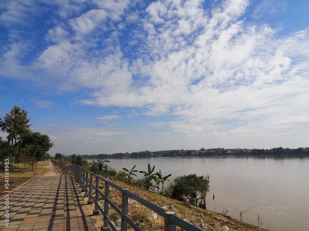 wooden bridge over the river
River Road Mekong Suitable for cycling. The atmosphere of the road to Mekong River. The Mekong River is a river between Thailand and Laos. Clear bright sky The villagers l