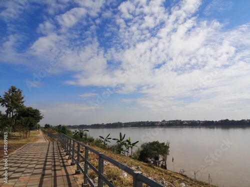 wooden bridge over the river River Road Mekong Suitable for cycling. The atmosphere of the road to Mekong River. The Mekong River is a river between Thailand and Laos. Clear bright sky The villagers l