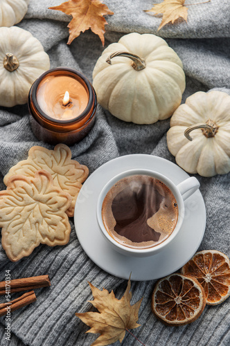 White pumpkins, coffee and autumn leaves