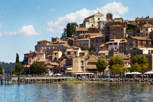 Fototapeta Naklejka Na Ścianę i Meble -  From the shores of Lake Bracciano rises the picturesque medieval village of Anguillara Sabazia with its beautiful architecture