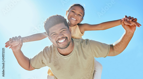 Father, child and holding hands on shoulder for happy relationship, bonding and smile in the outdoors. Portrait of dad and kid smiling in happiness for love, blue sky or care for piggyback in nature © J Maas/peopleimages.com