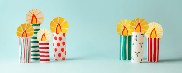 The child DIY for Jewish holiday of Hanukkah. Traditional candlestick 7 candles from toilet tube, recycle concept. Children's Art Project, needlework, crafts for children.