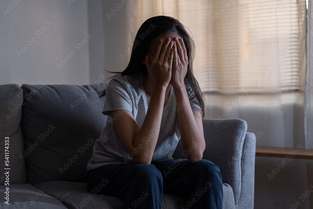 Mental health, depressed sad asian young woman, girl sitting on sofa, couch, expression to face difficulty, failure and exhausted. Thoughtful worried suffering depression feeling lonely, alone at home Mental health, depressed sad asian young woman, girl sitting on sofa, couch, expression to face difficulty, failure and exhausted. Thoughtful worried suffering depression feeling lonely, alone at home