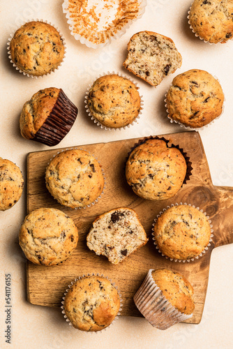 Chocolate banana muffins on a wooden board, top view