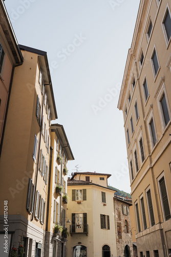 Historic architecture in Italy. Traditional European old town street buildings. Wooden windows, shutters and colourful pastel walls. Aesthetic summer vacation travel background